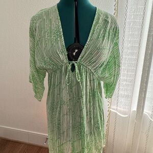 Green and white swimsuit coverup with drawstring tie in front.